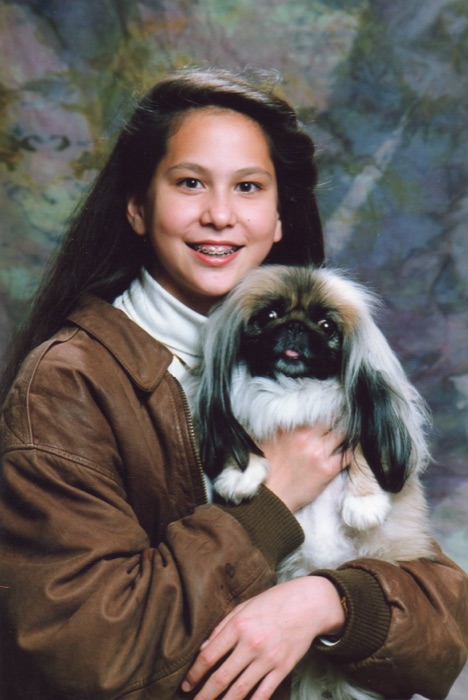 Amanda holding a small dog.